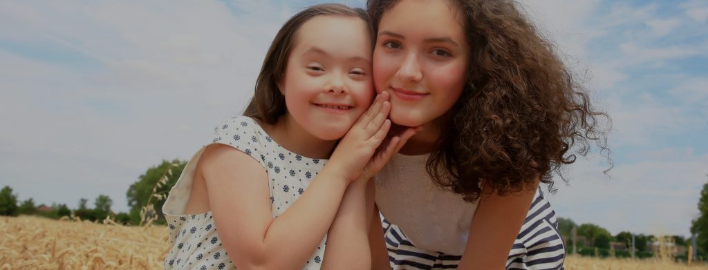 Two girls smiling for photo.